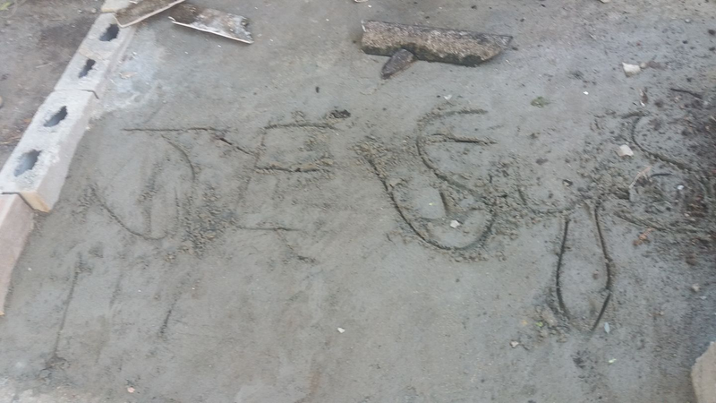 The drug traffickers wrote “Jesus” in the cement outside Flores’ home. (Courtesy of Carmen Flores)